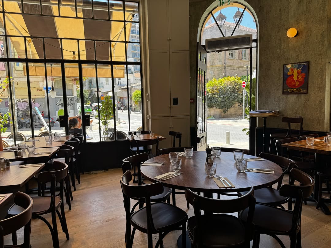 Tables dressées et grandes fenêtres de la salle Rendez-Vous donnant sur Lilienblum.